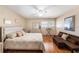 Spacious bedroom with hardwood floors, ceiling fan, and large window at 6308 Newtown Cir # 8C5, Tampa, FL 33615