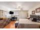 Bedroom with a large bed, TV, and dark hardwood floors at 6308 Newtown Cir # 8C5, Tampa, FL 33615