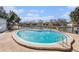 Community pool with beautiful lake view and relaxing lounge area, great for soaking up the sun at 6308 Newtown Cir # 8C5, Tampa, FL 33615
