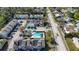 Aerial view showcasing a community with a pool, townhomes, and ample parking, emphasizing convenient living at 6640 121St Ave # 4, Largo, FL 33773