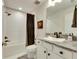Bathroom featuring a white sink, granite countertops, and a shower over the tub at 7528 Paradiso Dr, Apollo Beach, FL 33572