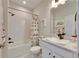 Bright bathroom with a white vanity, unique sink, and a shower/tub with a fun, themed shower curtain at 7528 Paradiso Dr, Apollo Beach, FL 33572
