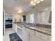 A luxurious bathroom featuring double sinks, granite countertops, and a serene atmosphere at 7528 Paradiso Dr, Apollo Beach, FL 33572