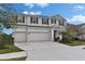 Charming two-story home with a three-car garage and a well-maintained front yard at 7528 Paradiso Dr, Apollo Beach, FL 33572