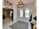 Bright foyer with a patterned rug under a decorative chandelier and an entryway table with hooks at 7528 Paradiso Dr, Apollo Beach, FL 33572