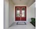 Elegant double front doors featuring glass panels and sleek hardware at 7528 Paradiso Dr, Apollo Beach, FL 33572