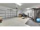 Spacious garage with epoxy floor, room for multiple cars, storage, and exercise equipment at 7528 Paradiso Dr, Apollo Beach, FL 33572