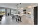Bright, open kitchen featuring a spacious island, white cabinetry, and modern lighting at 7528 Paradiso Dr, Apollo Beach, FL 33572