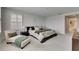 Bright main bedroom with a large bed, seating area and neutral decor at 7528 Paradiso Dr, Apollo Beach, FL 33572