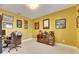 Bright home office with a glass-front display cabinet and collection of military memorabilia displayed on the walls at 7528 Paradiso Dr, Apollo Beach, FL 33572