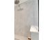 Close-up of a shower with gray tile surround and a shower head at 7528 Paradiso Dr, Apollo Beach, FL 33572