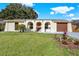 Charming home featuring arched entry and a well-manicured front lawn, creating excellent curb appeal at 7821 Yucca Dr, New Port Richey, FL 34653