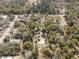 Wide aerial view showing the property amidst lush greenery, a serene neighborhood at 9641 Fulton Ave, Hudson, FL 34667