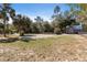 A spacious backyard with a well-maintained shed, mature trees, and hints of recreational space visible at 9641 Fulton Ave, Hudson, FL 34667