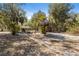 Spacious backyard featuring a firepit and tiki hut, perfect for outdoor gatherings at 9641 Fulton Ave, Hudson, FL 34667