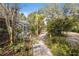 Landscaped backyard with a screened-in pool area, creating a tranquil outdoor retreat at 9641 Fulton Ave, Hudson, FL 34667