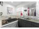 Bathroom features a dark soaking tub with a white stone accent wall at 9641 Fulton Ave, Hudson, FL 34667