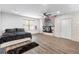 Large bedroom with hardwood floors, a ceiling fan, and a washer and dryer closet at 9641 Fulton Ave, Hudson, FL 34667
