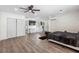 Open concept bedroom with hardwood floors, ceiling fan, and a closet at 9641 Fulton Ave, Hudson, FL 34667