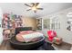 Unique bedroom with circular bed, fan, and lots of light at 9641 Fulton Ave, Hudson, FL 34667