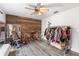 Multi-purpose bedroom with wood accent wall, exercise, and wardrobe area at 9641 Fulton Ave, Hudson, FL 34667