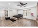Spacious bedroom featuring hardwood floors, a ceiling fan, and large windows at 9641 Fulton Ave, Hudson, FL 34667