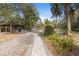 Charming community space with a gazebo, grill and a stone paver walkway amidst lush greenery at 9641 Fulton Ave, Hudson, FL 34667