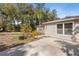 Exterior shot showcases the side of the house and the backyard patio at 9641 Fulton Ave, Hudson, FL 34667