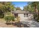 Charming single-story home with manicured landscaping and a cozy front porch and a concrete driveway at 9641 Fulton Ave, Hudson, FL 34667
