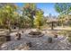 Charming fire pit area and tiki hut seating surrounded by lush trees and landscaping at 9641 Fulton Ave, Hudson, FL 34667