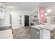 Modern kitchen featuring white cabinets, stainless steel appliances, and stylish lighting fixtures at 9641 Fulton Ave, Hudson, FL 34667