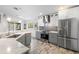 Bright kitchen with stainless steel appliances, white and gray cabinetry, and stylish backsplash at 9641 Fulton Ave, Hudson, FL 34667