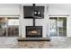 Cozy living room with a decorative fireplace, geometric wall accents, and sliding glass doors at 9641 Fulton Ave, Hudson, FL 34667