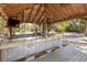 Unique outdoor kitchen and entertainment area featuring rope swings and outdoor television at 9641 Fulton Ave, Hudson, FL 34667
