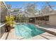 Screened-in pool and spa, complete with outdoor bar and shaded seating; perfect for relaxation and entertainment at 9641 Fulton Ave, Hudson, FL 34667