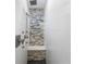 Modern tiled shower with mosaic stone floor and accent wall at 9641 Fulton Ave, Hudson, FL 34667