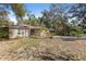 Home exterior and spacious yard, perfect for outdoor activities and enjoying nature at 9641 Fulton Ave, Hudson, FL 34667