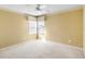 A sunny and neutral bedroom featuring a ceiling fan at 11444 Village Brook Dr, Riverview, FL 33579