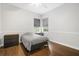 Bedroom with hardwood flooring, light grey walls, and dual windows with light-blocking blinds at 11505 Heron Hills Ln, Riverview, FL 33569