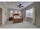 Spacious bedroom with large windows, ceiling fan, and decorative lamps at 11610 Griffith Park Ter, Bradenton, FL 34211