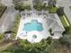 Aerial view of a community pool with lounge chairs and shaded cabanas for relaxation and enjoyment at 11610 Griffith Park Ter, Bradenton, FL 34211