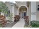 Inviting front entrance features an arched entryway, manicured landscaping, and a well-maintained facade at 11610 Griffith Park Ter, Bradenton, FL 34211