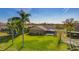 Large, well-maintained backyard featuring mature trees, a screened lanai, and ample space for outdoor activities at 12933 Prestwick Dr, Riverview, FL 33579