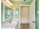 Bathroom featuring a bright green wall, single sink, and an adjacent open closet area at 2435 E Del Webb Blvd, Sun City Center, FL 33573