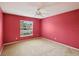 Bedroom with window and red walls providing bright light, creating a warm and inviting ambiance at 2435 E Del Webb Blvd, Sun City Center, FL 33573