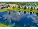 Picturesque community pond featuring a water fountain and scenic views of the community at 2435 E Del Webb Blvd, Sun City Center, FL 33573