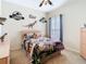 Themed bedroom with dinosaur decor, a ceiling fan and a window providing natural light at 25950 Risen Star Dr, Wesley Chapel, FL 33544