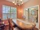Traditional dining room with hardwood floors, an ornate table, and decorative details at 25950 Risen Star Dr, Wesley Chapel, FL 33544