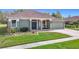 Charming single-story home with a well-manicured lawn, complemented by a two-car garage and welcoming front porch at 25950 Risen Star Dr, Wesley Chapel, FL 33544