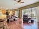 Bright and airy living room features hardwood floors and sliding glass doors leading to the screened-in patio at 25950 Risen Star Dr, Wesley Chapel, FL 33544